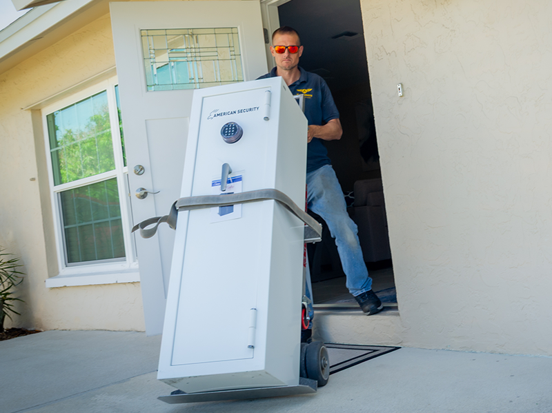 "A" Locksmith technician moving a large safe using a dolly